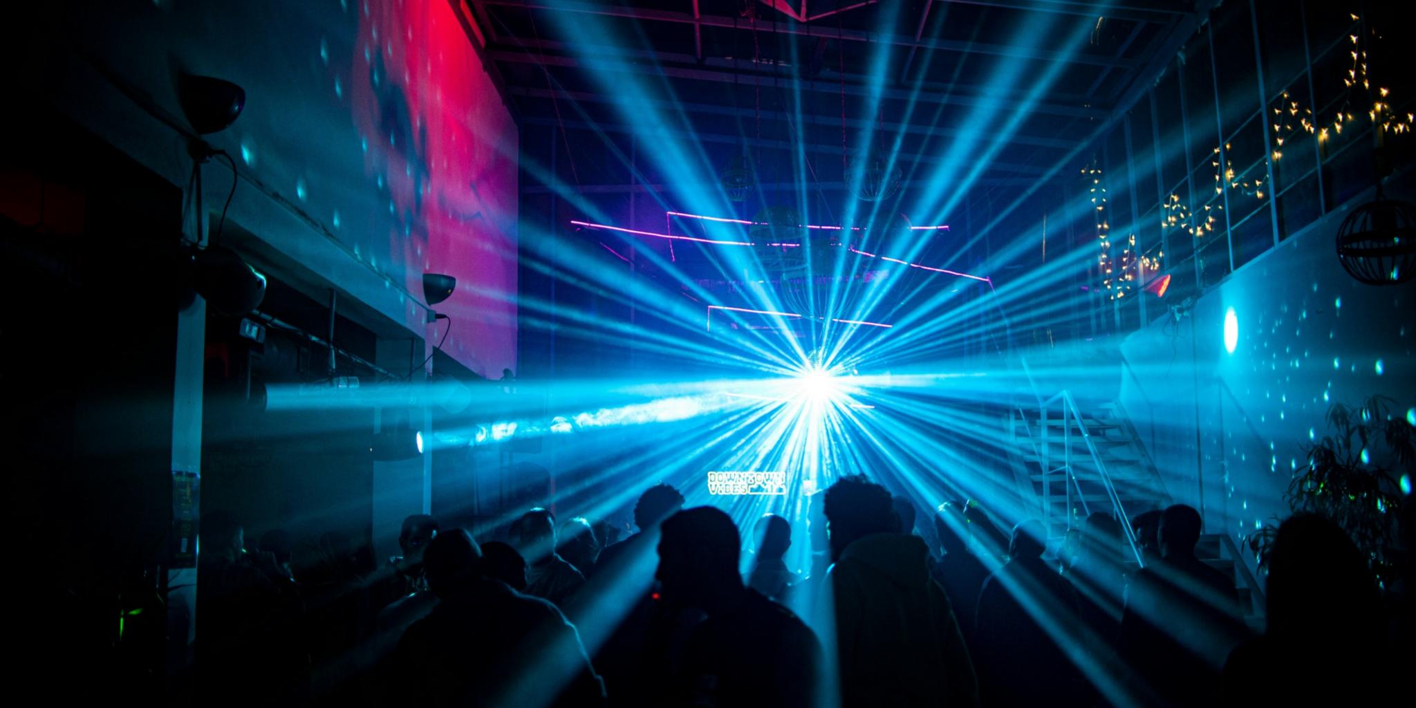 blau rotes Partylicht mit tanzenden Menschen im Vordergrund